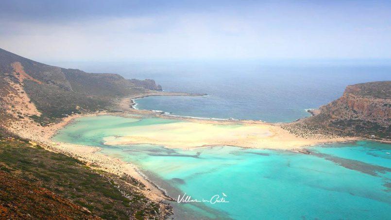 Why do the beaches at Elafonisi and Balos have pink sand?